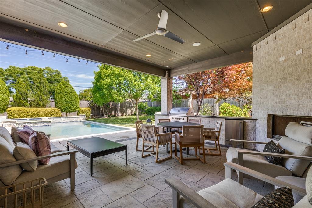 3755 Northview Lane Dallas, TX 75229 - Photo 33 of 36 View from the back patio overlooking the expansive green space and pool & spa with a water feature.