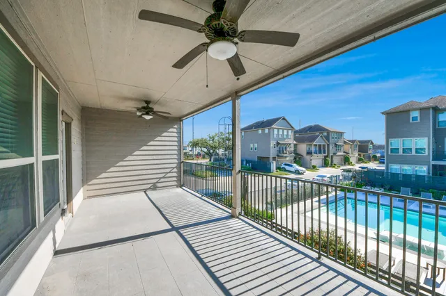 a view of a balcony with a ceiling fan