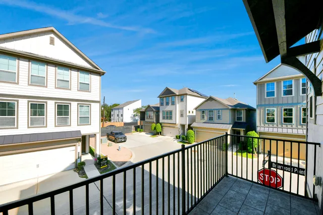 a view of a house with a wooden deck