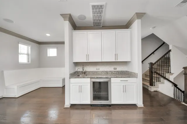 a kitchen with a stove and white cabinets
