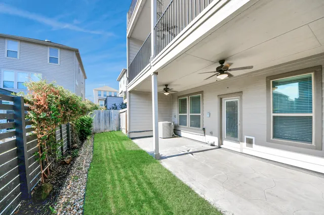 a view of house with backyard and glass windows