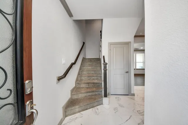 a view of entryway and hall with wooden floor