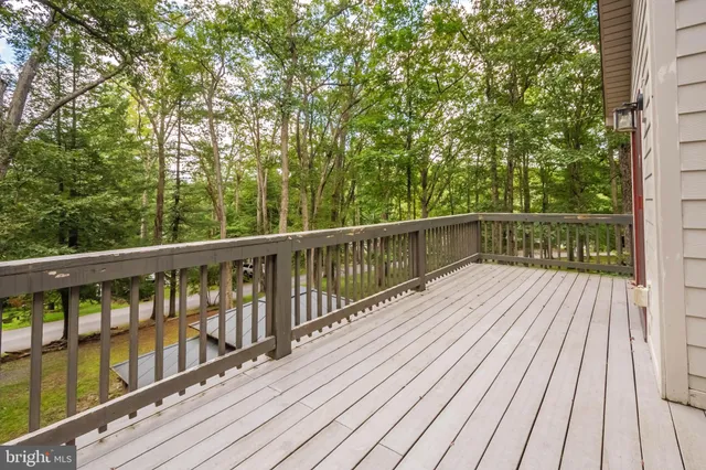 a view of balcony with wooden floor and fence