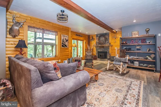 a living room with furniture a couch and large windows