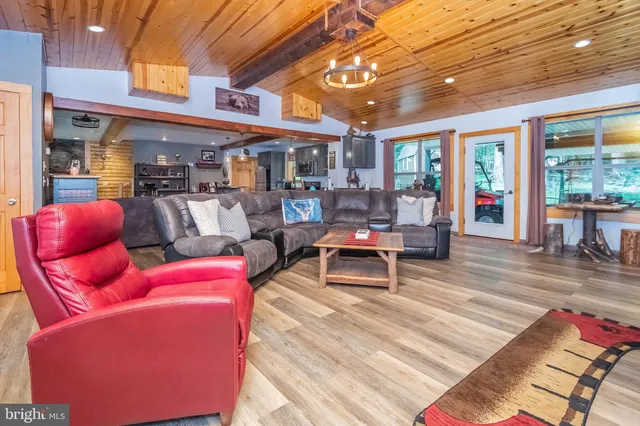a living room with furniture a large window and rug