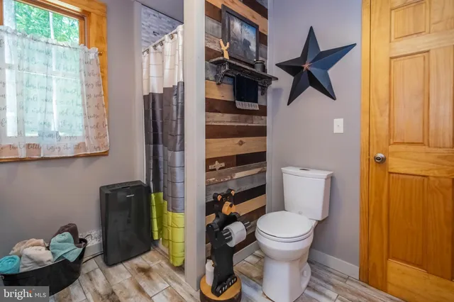 a bathroom with a toilet and a shower