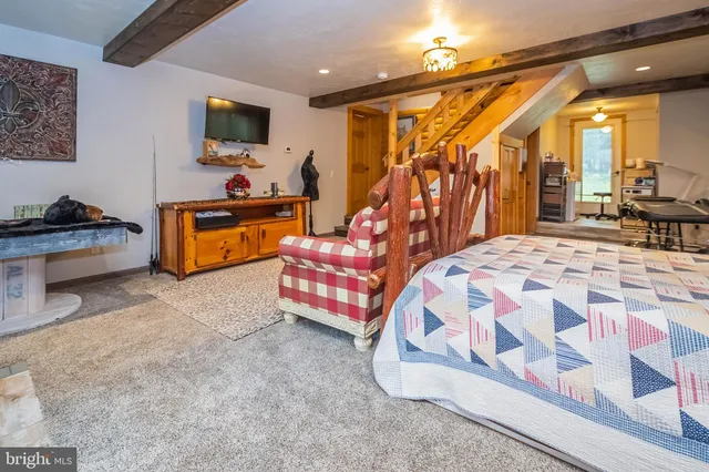 a bedroom with furniture and a flat screen tv