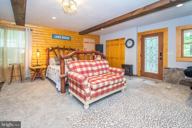 a bedroom with a bed and large windows