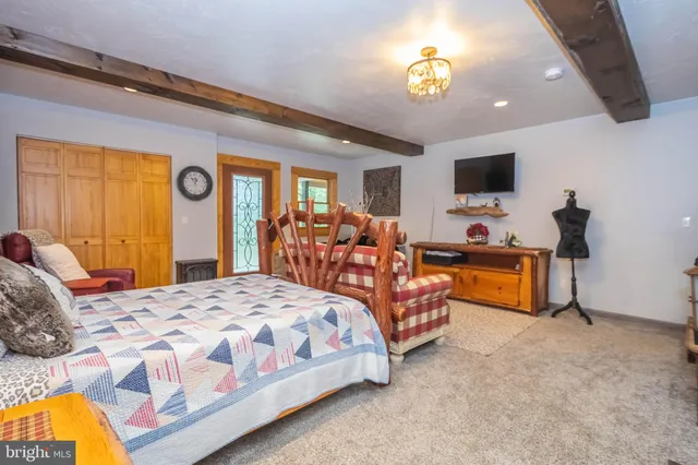 a bedroom with a bed and flat screen tv