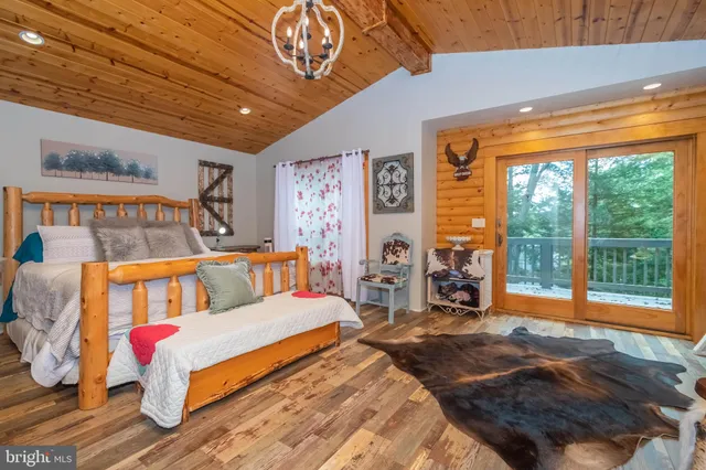 a bedroom with furniture and a large window