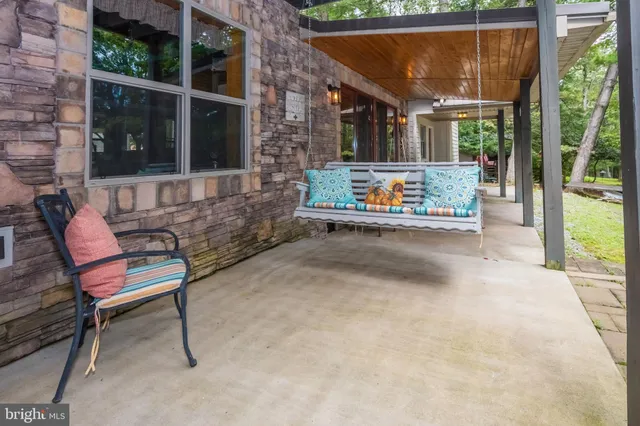 a view of patio with a table and chairs and potted plants