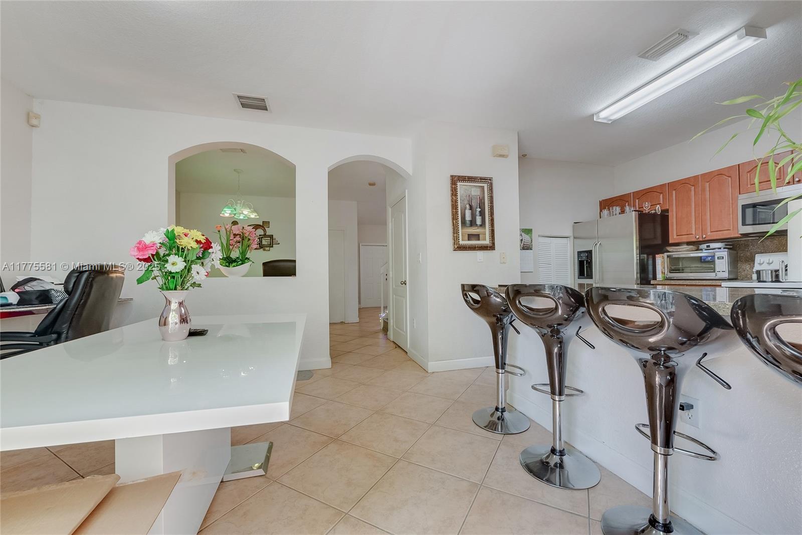 21441 Southwest 85th Path Cutler Bay, FL 33189 - Photo 10 of 17 a dining room with furniture and potted plants