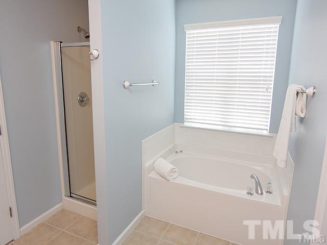 9826 Grettle Court Raleigh, NC 27617 - Photo 6 of 9 a white bath tub sitting next to a window