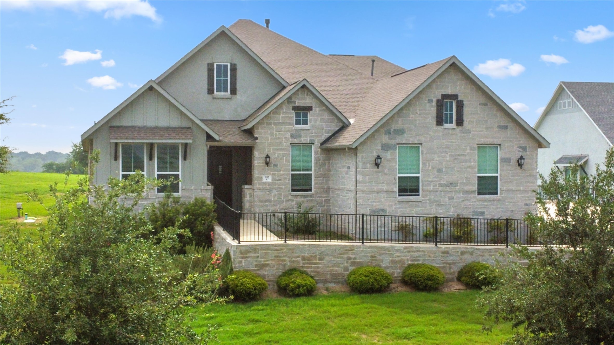 192 Raptor Beak Way Cedar Creek, TX 78612 - Photo 2 of 38 Stone and stucco exterior featuring multiple gables