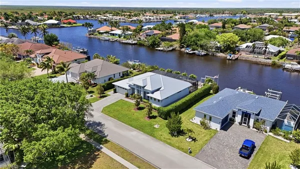 an aerial view of a house with yard swimming pool and outdoor seating