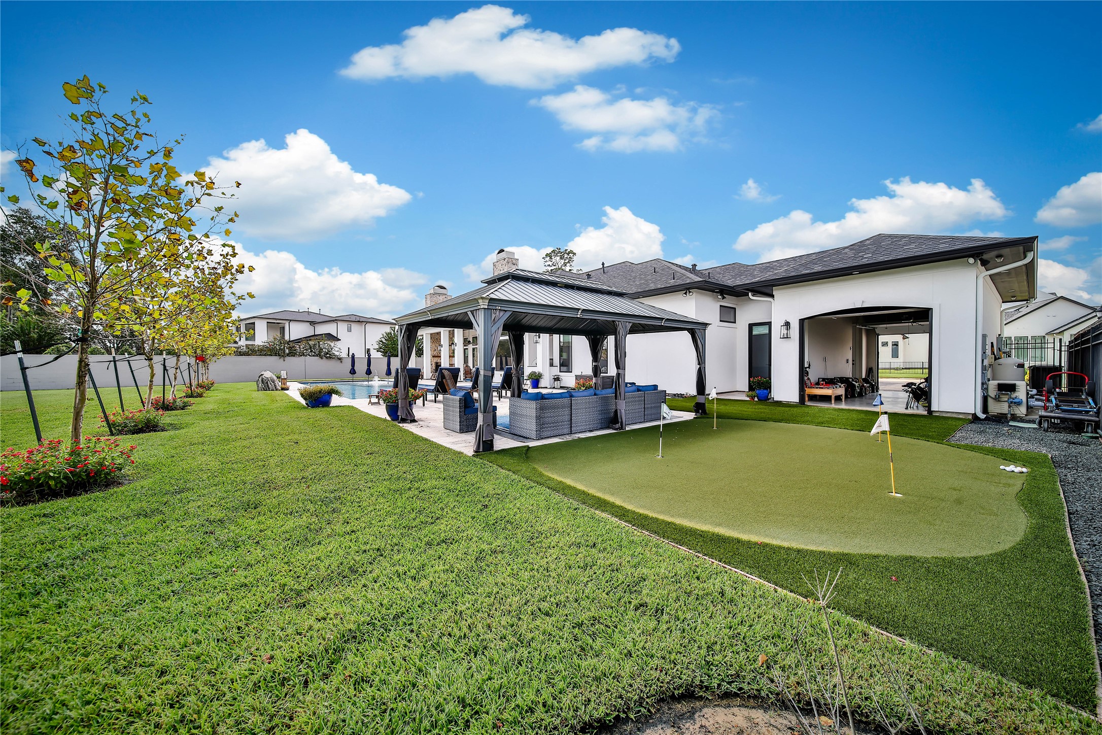 24718 Shadow Pond Spring, TX 77389 - Photo 43 of 49 Expansive backyard features a charming gazebo, pristine putting green, and lush landscaping, perfect for relaxation and outdoor entertainment.