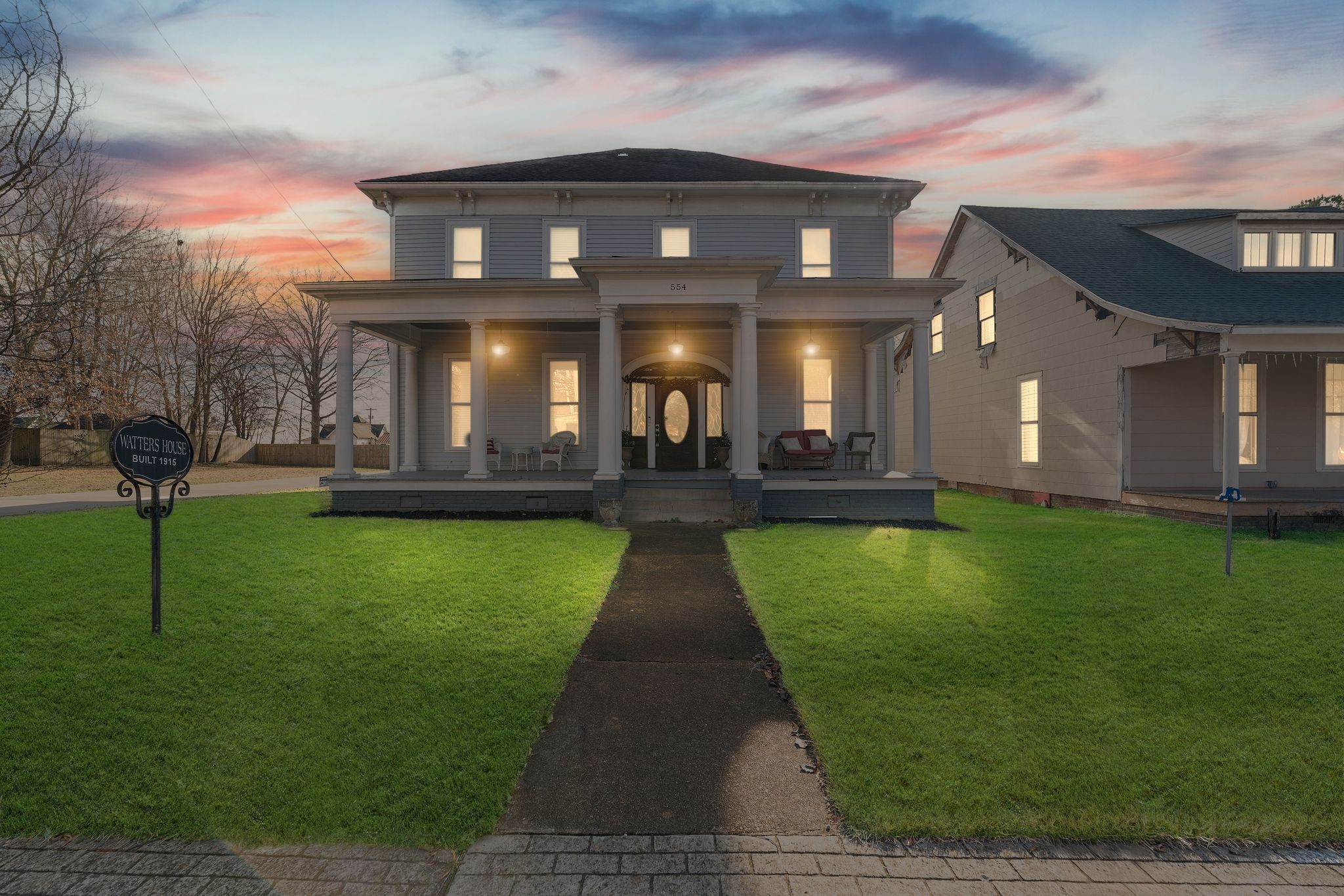 a view of a brick building next to a yard