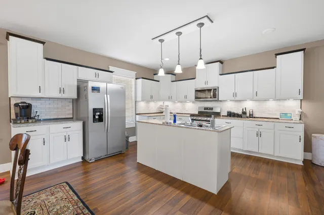 a living room with furniture a chandelier and a fireplace