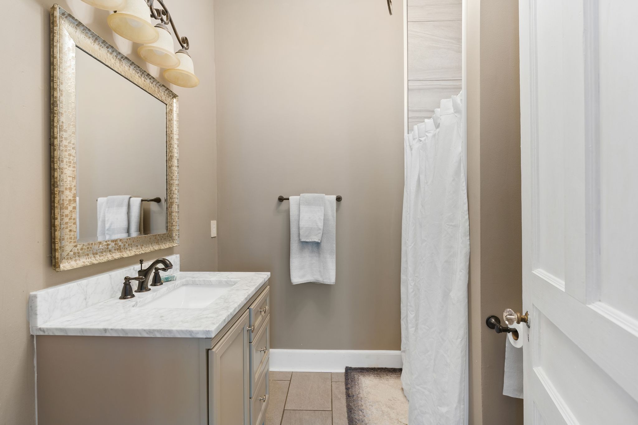 554 East Main Street Jackson, TN 38301 - Photo 26 of 38 a bathroom with a granite countertop sink and a mirror