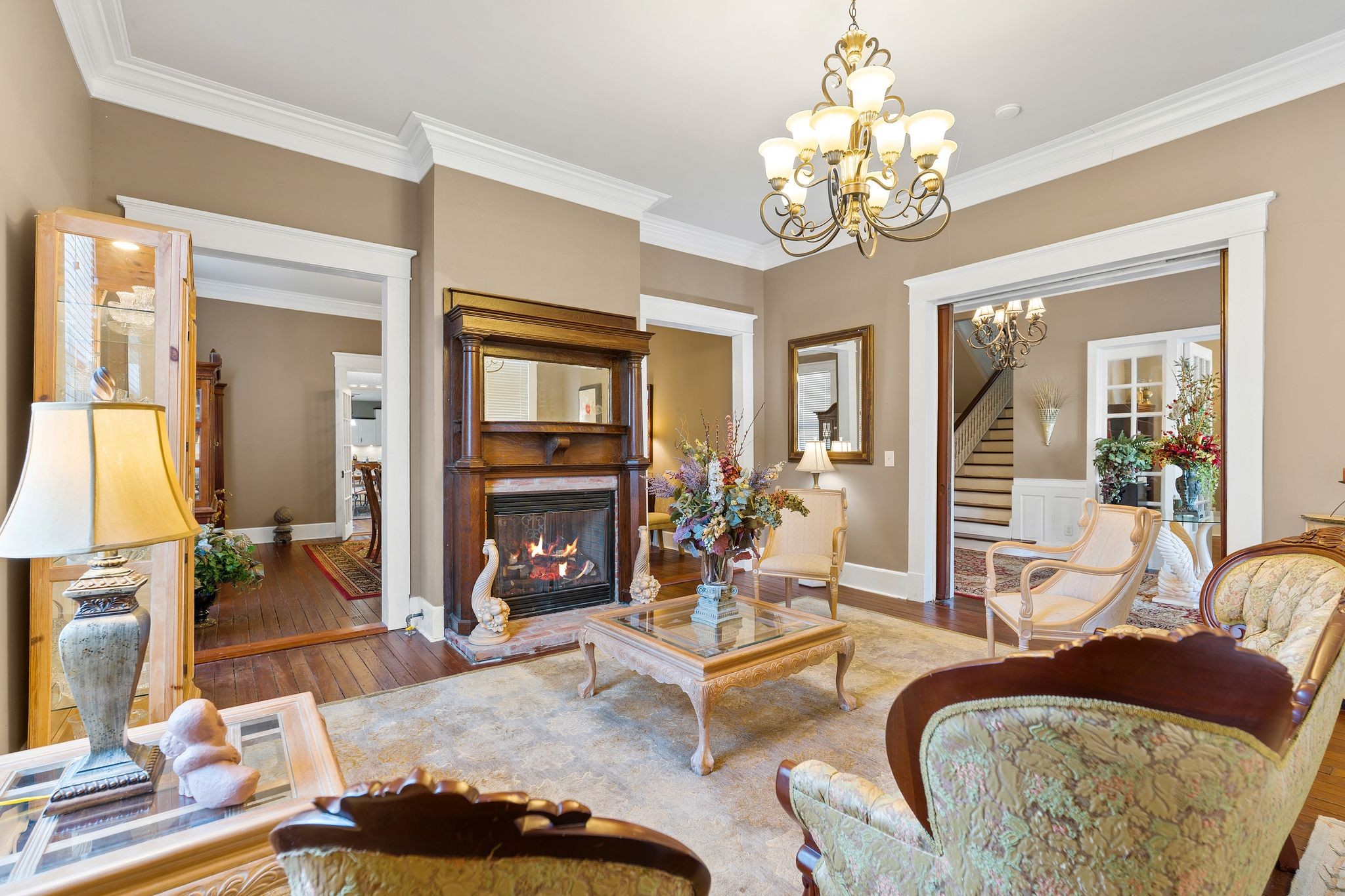 554 East Main Street Jackson, TN 38301 - Photo 3 of 38 a living room with furniture a chandelier and a fireplace