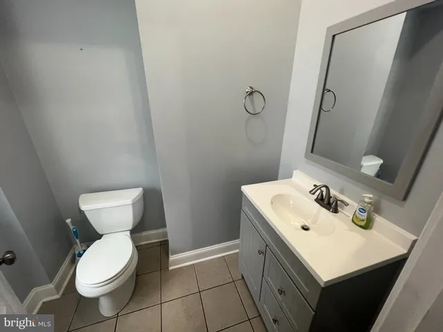 a bathroom with a sink toilet and mirror
