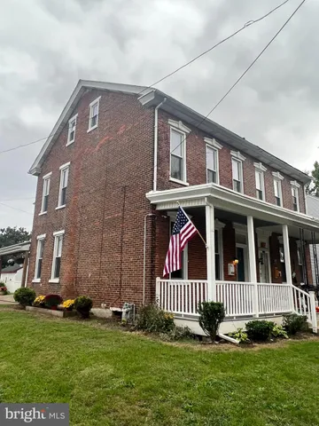 a view of a brick house with a yard