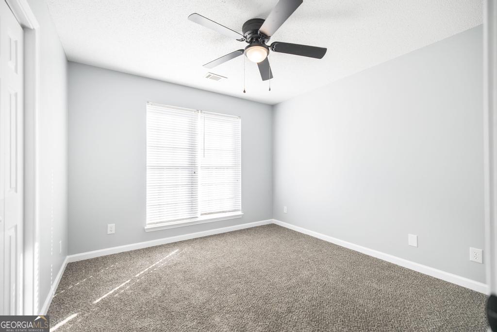 105 Browning Point Byron, GA 31008 - Photo 18 of 39 an empty room with a window and a fan