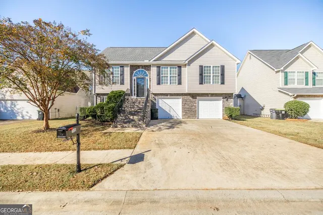 a front view of a house with a yard