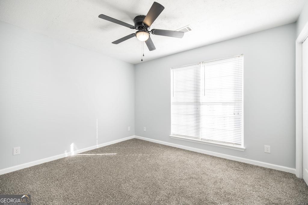 105 Browning Point Byron, GA 31008 - Photo 21 of 39 an empty room with a window and a fan
