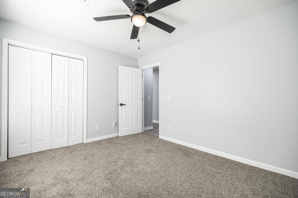 105 Browning Point Byron, GA 31008 - Photo 22 of 39 an empty room with closet and a chandelier fan