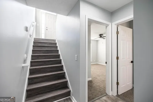 a view of a hallway with wooden floor and entryway