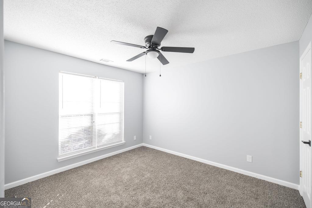 105 Browning Point Byron, GA 31008 - Photo 29 of 39 an empty room with a window and a fan