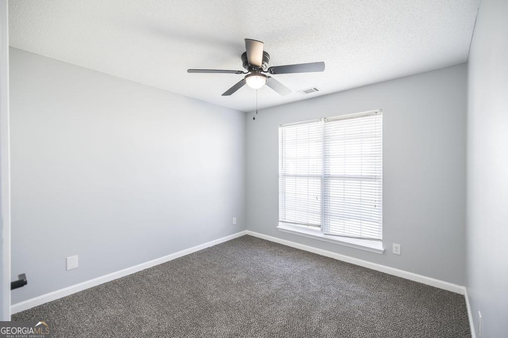 105 Browning Point Byron, GA 31008 - Photo 31 of 39 an empty room with windows and fan