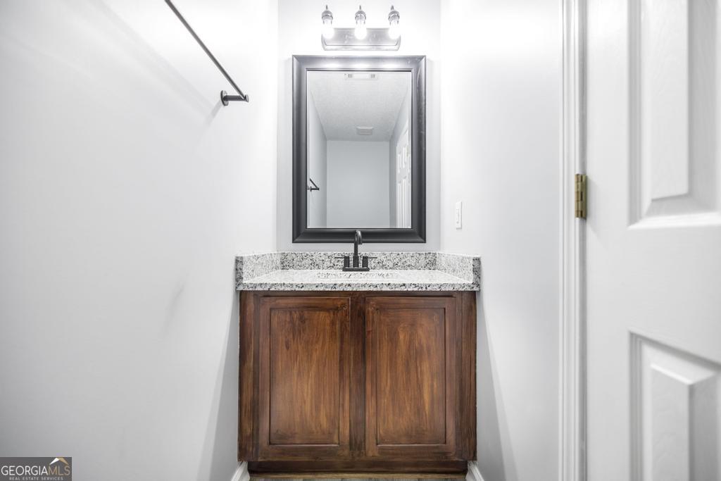 105 Browning Point Byron, GA 31008 - Photo 34 of 39 a bathroom with a granite countertop sink and a mirror