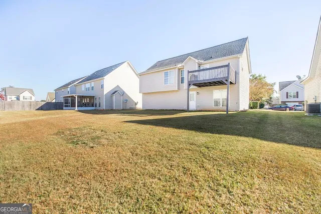 a view of a house with a swimming pool and a yard