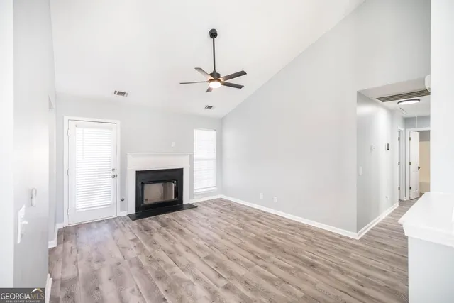 a view of an empty room with a fireplace