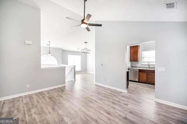 a view of a kitchen with a sink and a stove top oven