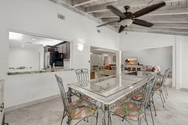 a dining room with a table and chairs
