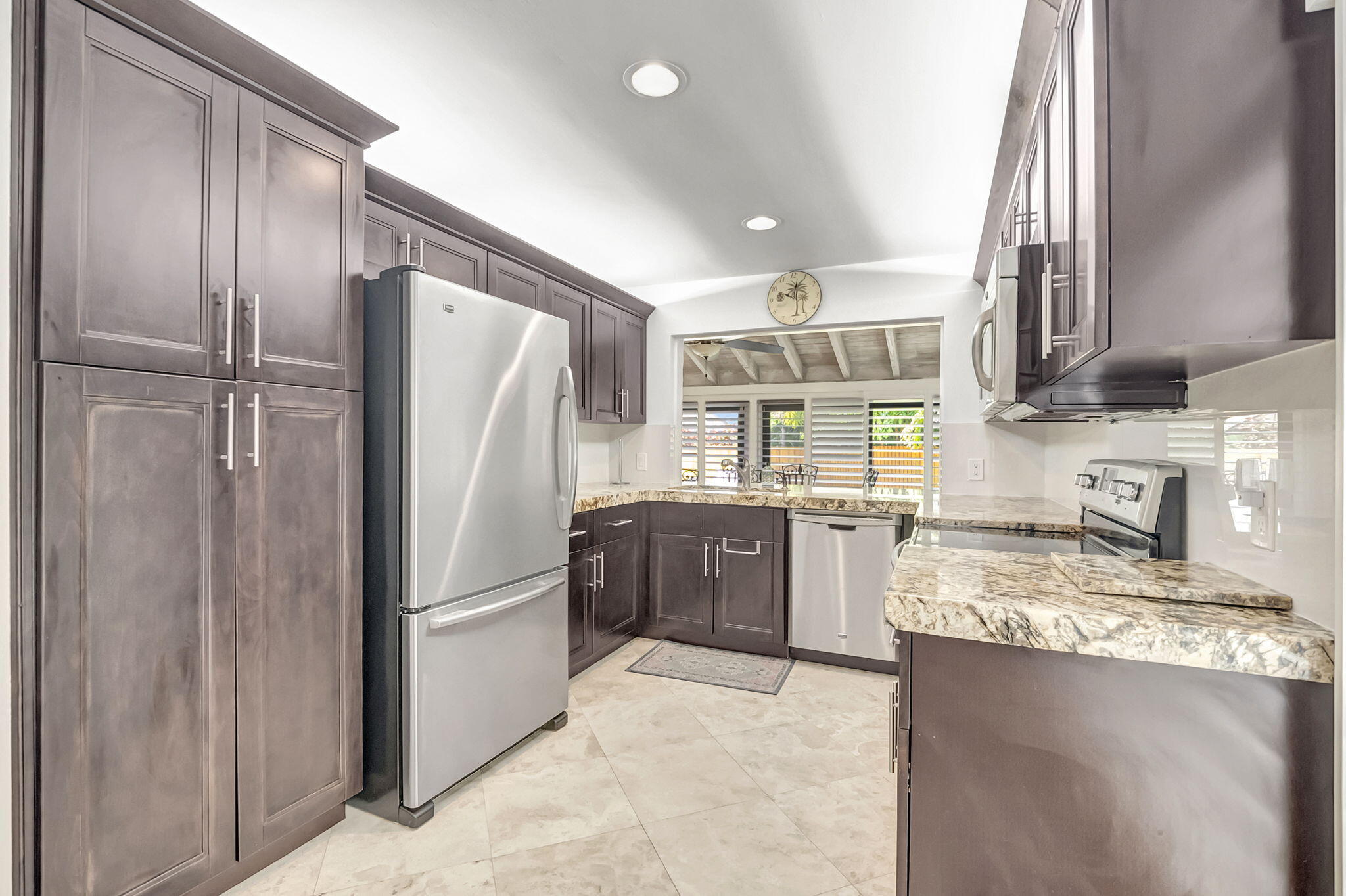 804 Foxpointe Circle Delray Beach, FL 33445 - Photo 16 of 43 a kitchen with stainless steel appliances granite countertop a refrigerator and a sink