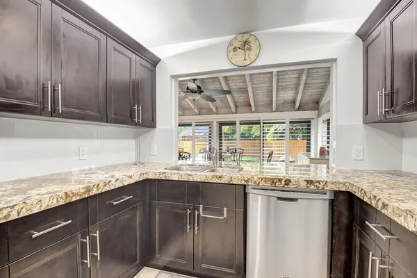 a kitchen with granite countertop a sink and a window