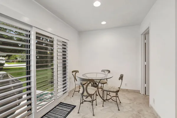 a view of a room with a table and chairs