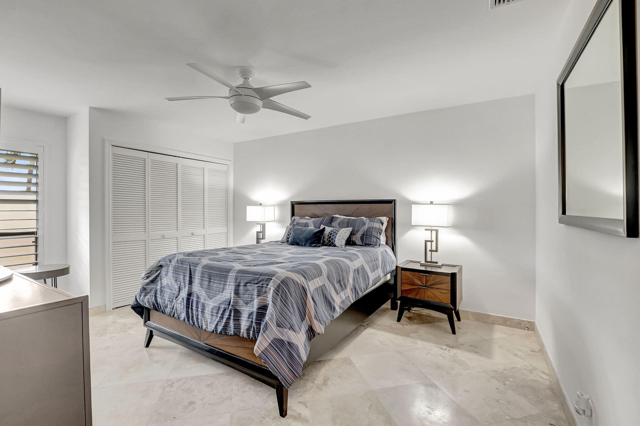 804 Foxpointe Circle Delray Beach, FL 33445 - Photo 27 of 43 a bedroom with a bed and a chandelier