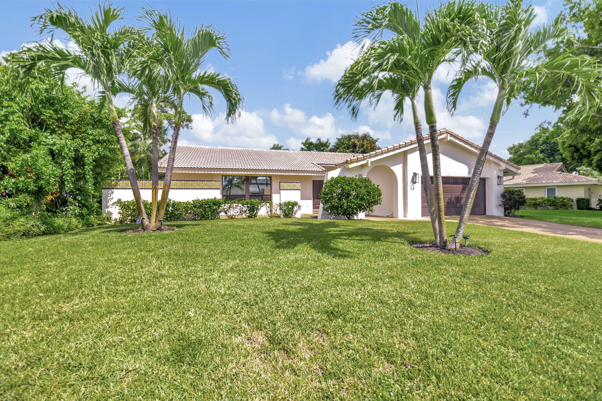 804 Foxpointe Circle Delray Beach, FL 33445 - Photo 3 of 43 a front view of a house with garden
