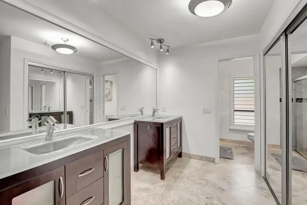 a spacious bathroom with a sink double vanity and a mirror