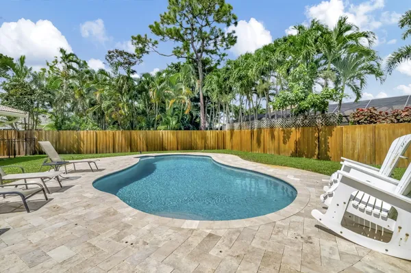 a view of a swimming pool with sitting area