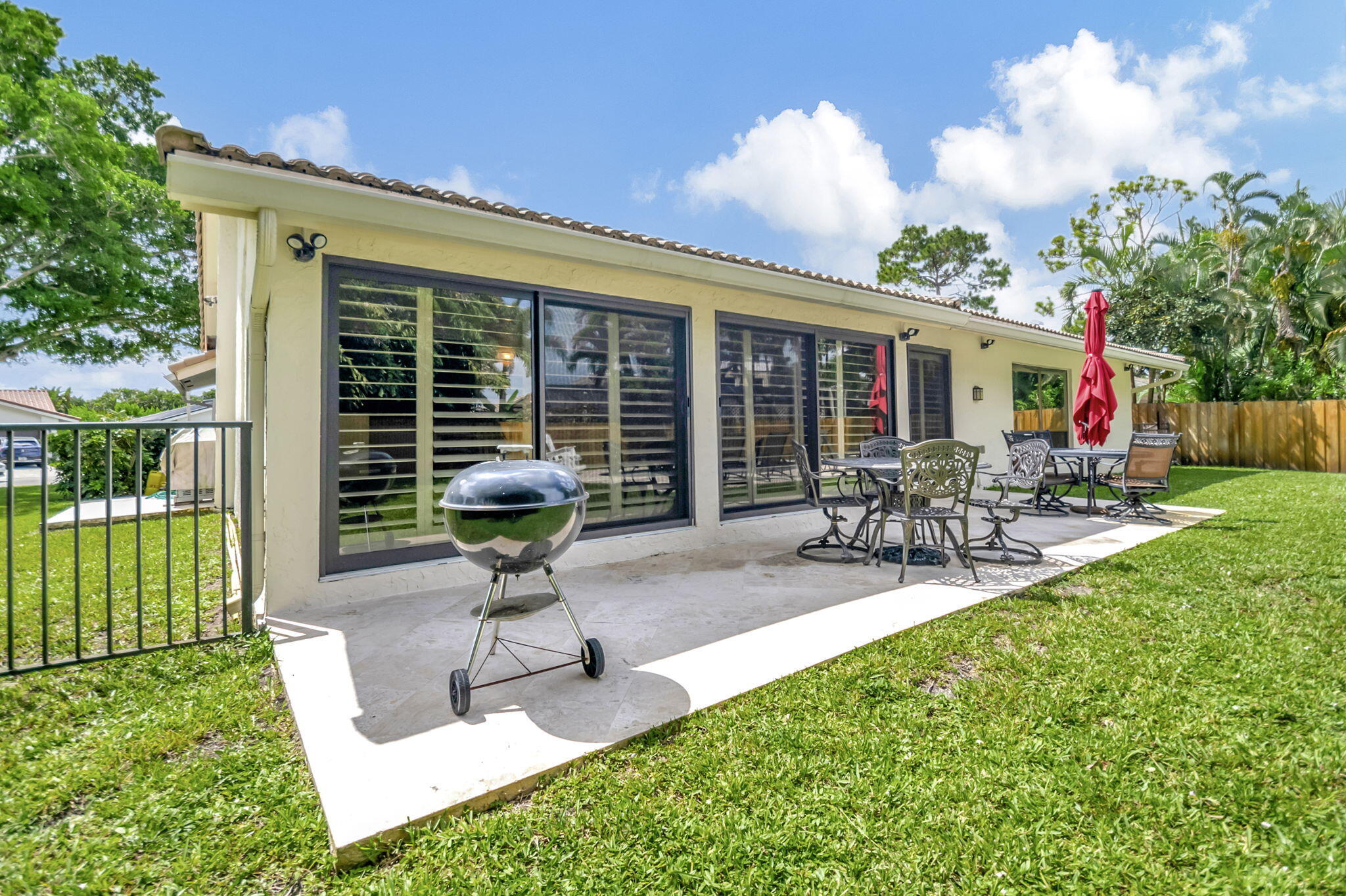 804 Foxpointe Circle Delray Beach, FL 33445 - Photo 43 of 43 a front view of a house with garden and patio