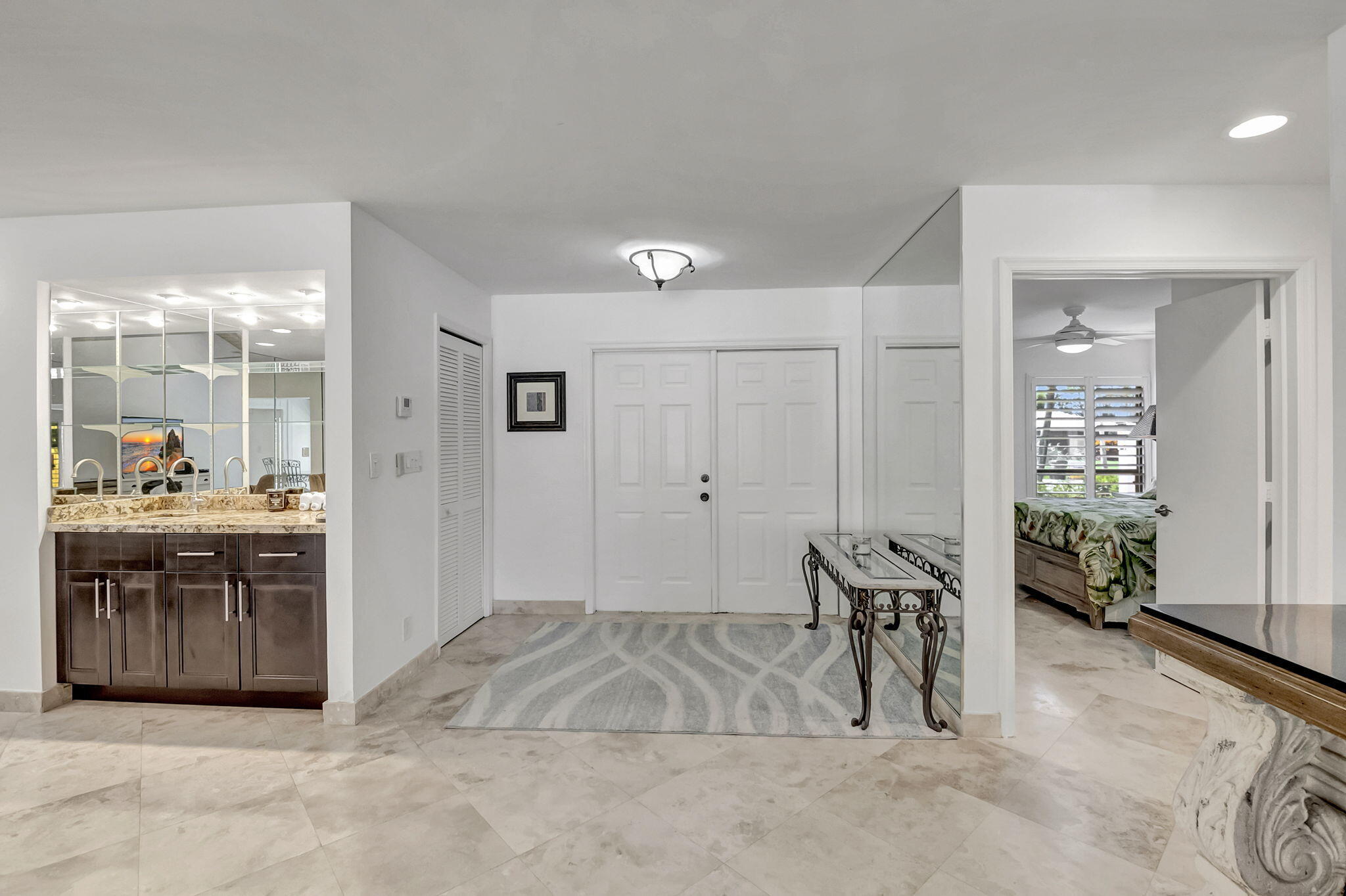 804 Foxpointe Circle Delray Beach, FL 33445 - Photo 6 of 43 a spacious bathroom with a granite countertop sink a mirror and a tub