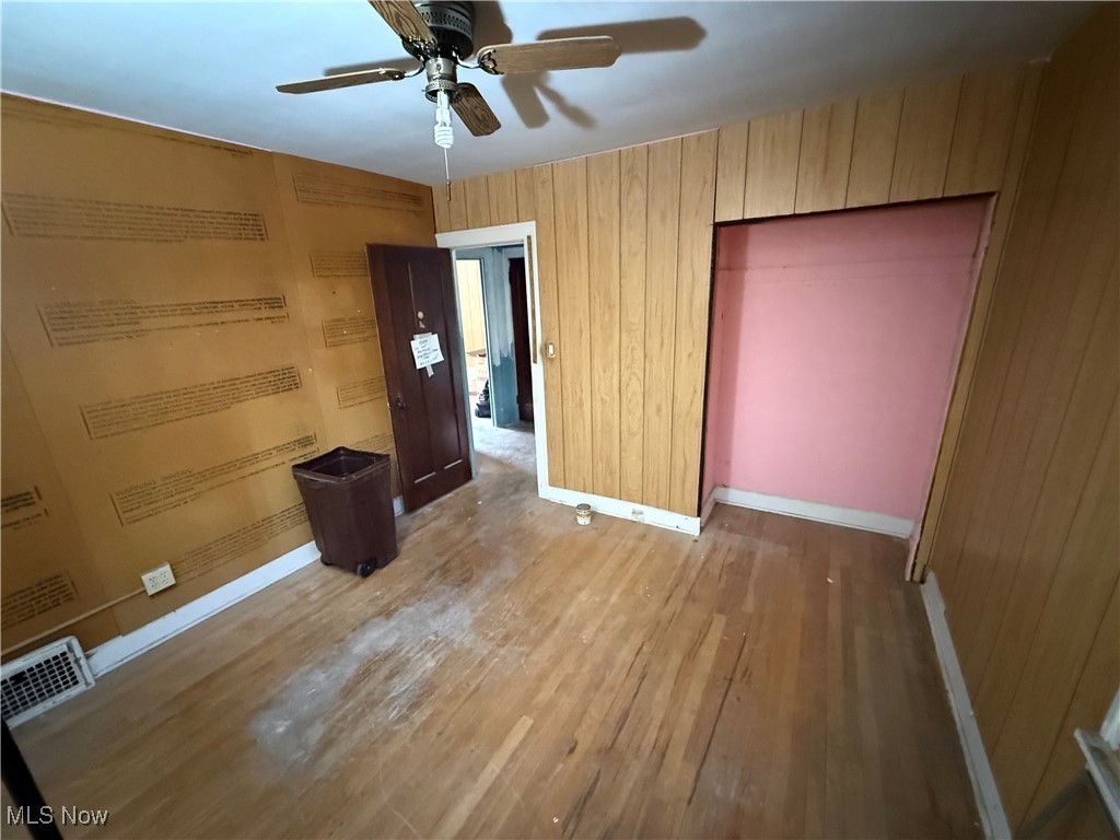 1058 Pembrook Road Cleveland Heights, OH 44121 - Photo 35 of 39 Unfurnished bedroom with wood finished floors, ceiling fan, and wooden walls