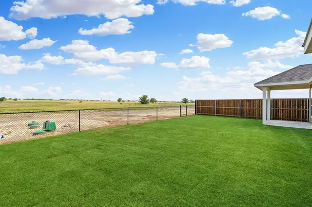 a view of yard with swimming pool and green space