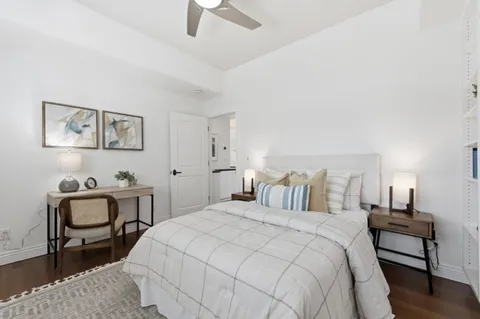 a bedroom with a bed and a lamp on table